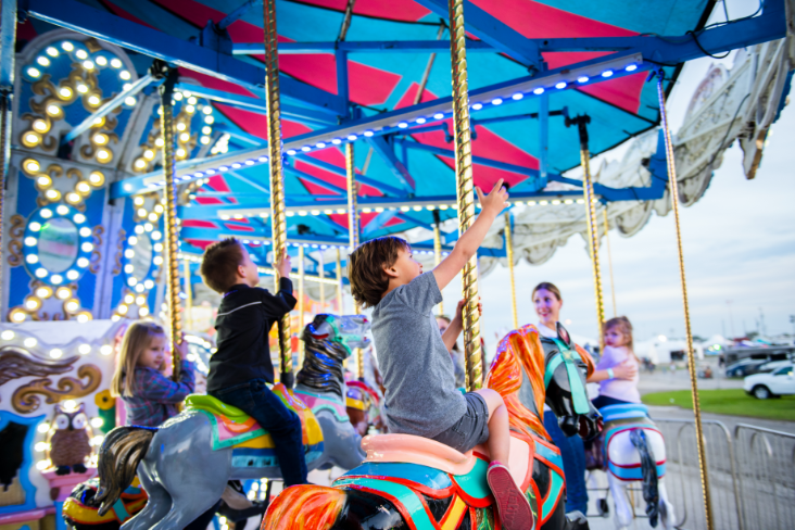 kids riding carousel