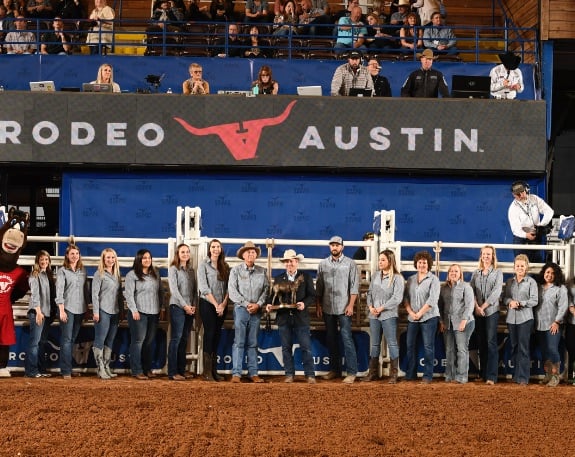 Rodeo Austin Staff with Top Hand Winner in arena