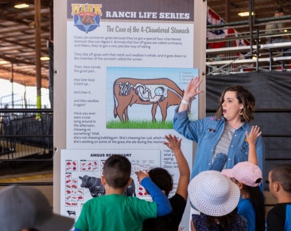 A woman talking to a group of children about ranch life at a Rodeo Austin School Tour.