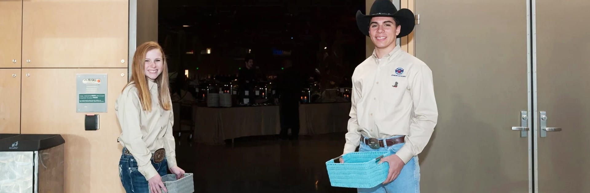 Two Rodeo Austin Junior Leaders smiling while taking tickets at the Rodeo Austin Gala