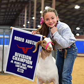 Girl posed with champion junior market goat show